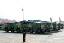 FILE - Military vehicles carrying hypersonic missiles DF-17 drive past Tiananmen Square during the military parade marking the 70th founding anniversary of People's Republic of China, on its National Day in Beijing, China October 1, 2019.