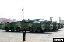 FILE PHOTO: Military vehicles carrying hypersonic missiles DF-17 drive past Tiananmen Square during the military parade marking the 70th founding anniversary of People's Republic of China, on its National Day in Beijing, China October 1, 2019.