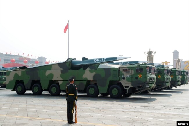 FILE - Military vehicles carrying hypersonic missiles DF-17 drive past Tiananmen Square during the military parade marking the 70th founding anniversary of People's Republic of China, on its National Day in Beijing, China October 1, 2019.