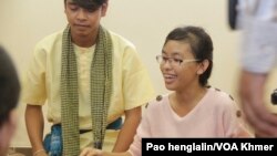 Tang Kimjeng a student of Royal University of Law and Economic is playing Khmer Traditional Instruments in the Exhibition of Cambodian Traditional Instrument at Cambodia-Japan cooperation center (CJCC). (Pao henglalin/VOA Khmer)