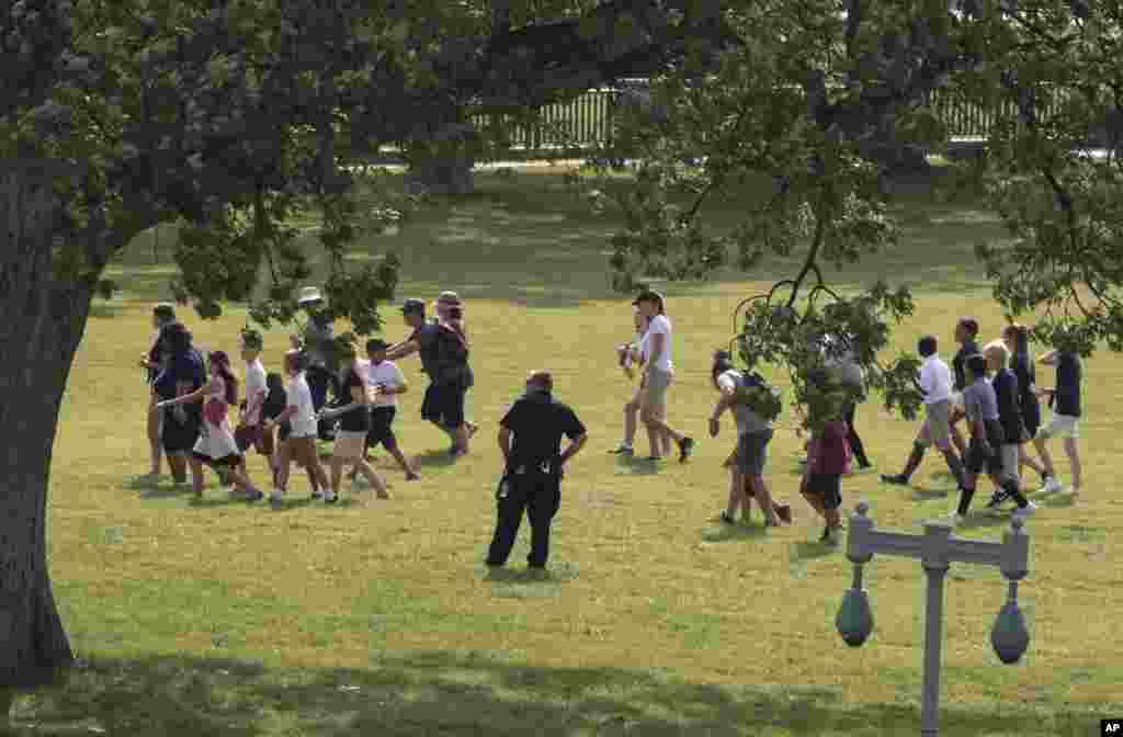 Tourists are directed away from the Capitol Building and across the lawn by Capitol Hill Police officers, June 14, 2017, after House Majority Whip Steve Scalise was shot at a Congressional baseball practice in Alexandria, Virginia.