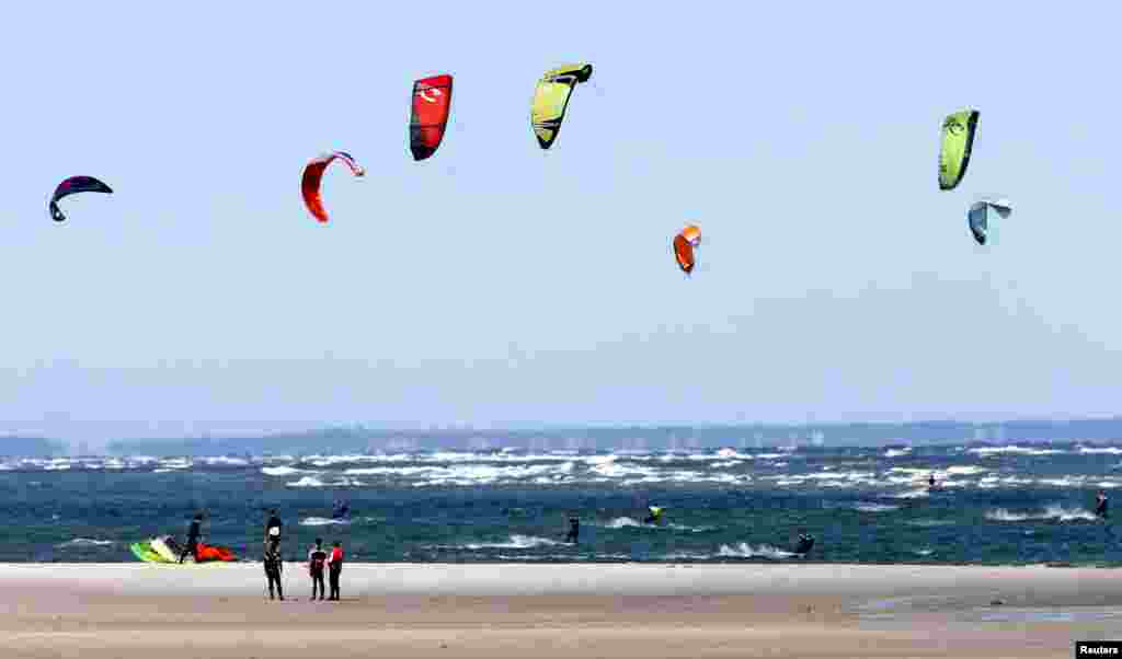 Kite surfers enjoy strong northeast winds off Chapin Beach in Dennis, Massachusetts, on Cape Cod Bay, Sept. 14, 2014.