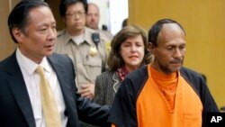 FILE - Jose Ines Garcia Zarate, right, is led into the courtroom by San Francisco Public Defender Jeff Adachi, left, and Assistant District Attorney Diana Garcia, center, for his arraignment in San Francisco, July 7, 2015.