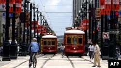 Two streetcars move along Canal Street in New Orleans, Louisiana