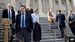 Rep. Raul Labrador (2nd from L) and members of the House of Representatives leave after the Republican-controlled House voted to let insurance companies sell individual health coverage to all comers, even if it falls short of required standards in "Obamac