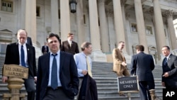 Rep. Raul Labrador (2nd from L) and members of the House of Representatives leave after the Republican-controlled House voted to let insurance companies sell individual health coverage to all comers, even if it falls short of required standards in "Obamac