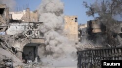 Smoke rises after a landmine exploded as fighters of Syrian Democratic Forces are clearing roads after the liberation of Raqqa, Syria October 18, 2017. 