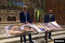 Two 1:1 scale photographic books depicting Sistine Chapel are seen during a news conference in the Sistine Chapel, the Vatican, Feb. 24, 2017.