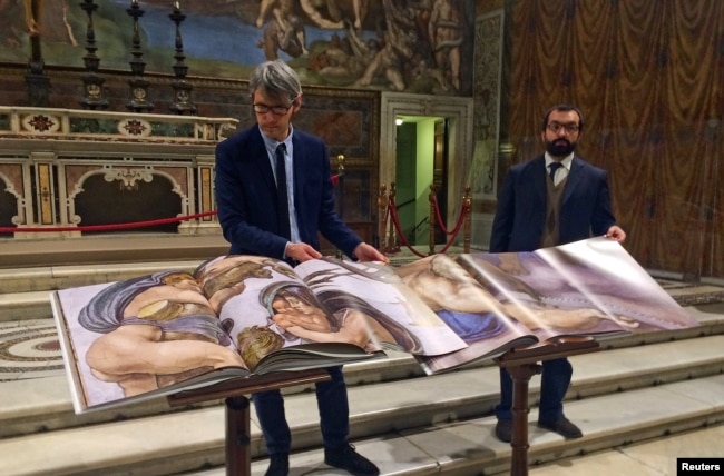 Two 1:1 scale photographic books depicting Sistine Chapel are seen during a news conference in the Sistine Chapel, the Vatican, Feb. 24, 2017.