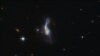 Objecto celestial IRAS 14348-1447, uma combinação de duas galáxias gasosas em espiral, está a mil milhões de anos-luz de distância da Terra.