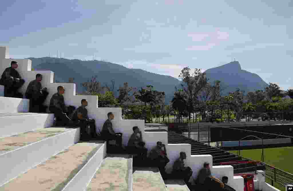 Security personnel sit in the stands and watch the Netherlands soccer team during a training session in Rio de Janeiro, Brazil, June 8, 2014. 