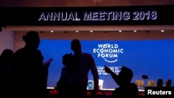 Staff talk in the Congress Hall ahead of the World Economic Forum (WEF) annual meeting in the Swiss Alps resort of Davos, Switzerland, Jan. 22, 2018. 