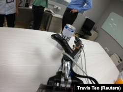 A robotic hand with the AiFoam reaches for a can at National University Singapore's Materials Sciences and Engineering lab in Singapore June 30, 2021.