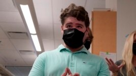 Jake met the mice and the researchers at Washington University in St. Louis, Dec. 15, 2021, in St. Louis. (AP Photo/Jeff Roberson)