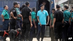 Handcuffed border guards arrive at a special court in Dhaka, Bangladesh, Nov. 5, 2013.