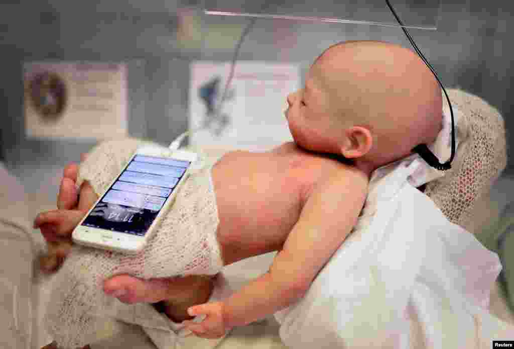 A Babyclon Animatronic baby is displayed at the Bilbao Reborn Doll Show, a trade fair featuring hyperrealist silicone and vinyl babies, known as &quot;Reborns&quot;, in Bilbao, northern Spain.