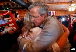 Former Florida Gov. Jeb Bush, a candidate for the Republican presidential nomination in 2016, hugs an audience member during a campaign event at Greasewood Flats Ranch in Carroll, Iowa, Jan. 29, 2016.