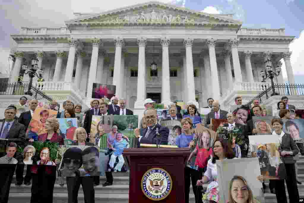 Senate Minority Leader Sen. Chuck Schumer of N.Y. and his fellow Democratic Senators, hold photographs of constituents who would be adversely affected by the proposed Republican Senate healthcare bill, during a news conference outside the Capitol Building in Washington.