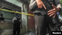 Police are seen outside the house of a person suspected of being linked to suicide bombings in Bandung, West Java, Indonesia, May 26, 2017.