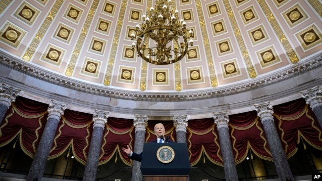 President Joe Biden delivers remarks on the one year anniversary of the January 6 attack on the U.S. Capitol, during a ceremony in Statuary Hall, Thursday, Jan. 6, 2022 at the Capitol in Washington. (Drew Angerer/Pool via AP)