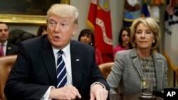 President Donald Trump accompanied by Education Secretary Betsy DeVos, speaks during a meeting with parents and teachers, Feb. 14, 2017, in the Roosevelt Room of the White House in Washington. 