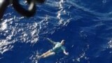 A man who used his jeans as a makeshift flotation device, after being knocked off a yacht and stranded at sea, is rescued by a helicopter, off Tolaga Bay in Gisborne, New Zealand, March 6, 2019. (Lowe Corporation Rescue Helicopter Service/Handout via REUTERS)