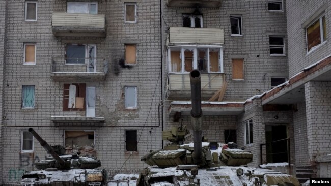 FILE - Tanks are seen in the government-held industrial town of Avdiyivka, Ukraine, Feb. 2, 2017.