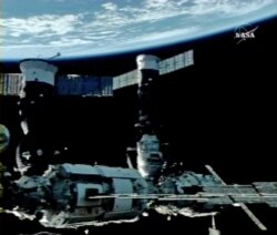 In this image from NASA Television, Earth is the background as the International Space Station is seen during a space walk by Cosmonauts Fyodor Yurchikhin and Oleg Kotov