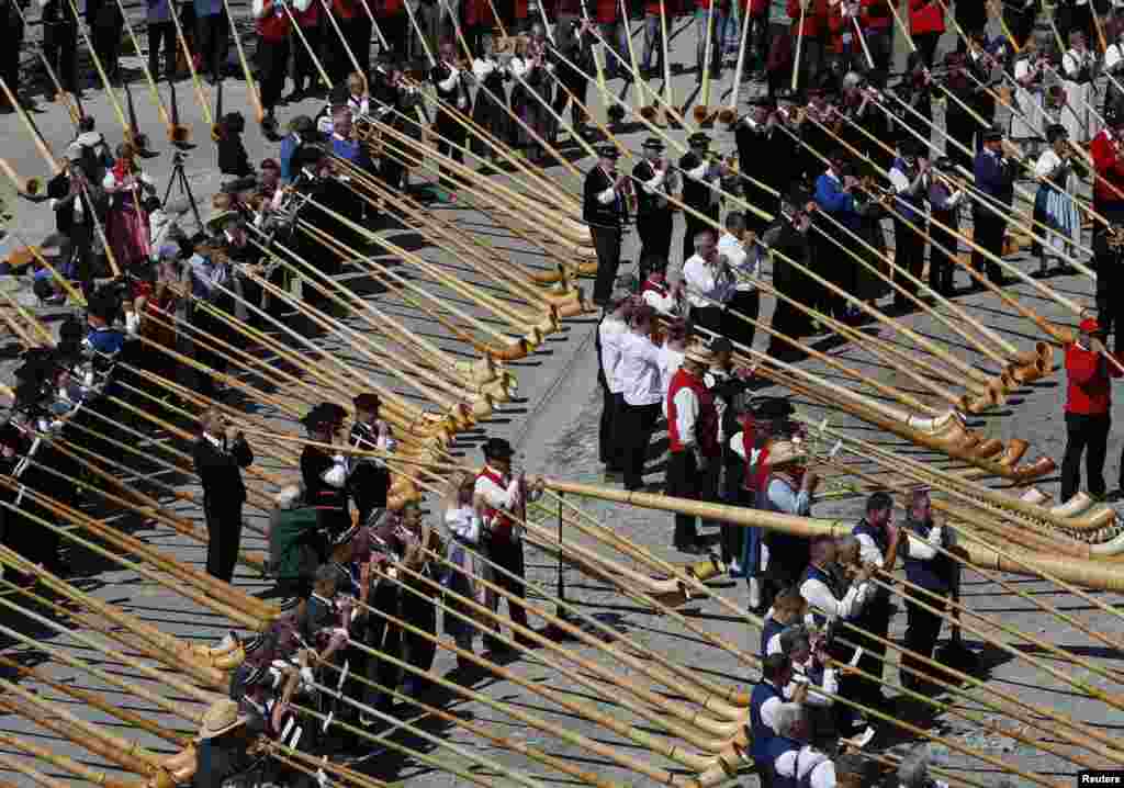 Alphorn players blow their instruments in an attempt to break the world record for the largest ensemble of people playing the alphorn, on the Gornergrat in front of the Matterhorn mountain near Zermatt, 3,089 metres (10,135 feet) above sea level in Switzerland.