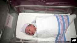 Newborn baby Makenzie, daughter of Stephanie Sanchez, 25, and Kenneth Vega, is wheeled to a nursery after she was born at 10:25am at Wyckoff Heights Medical Center in the Brooklyn borough of New York (October 2011 file photo) 