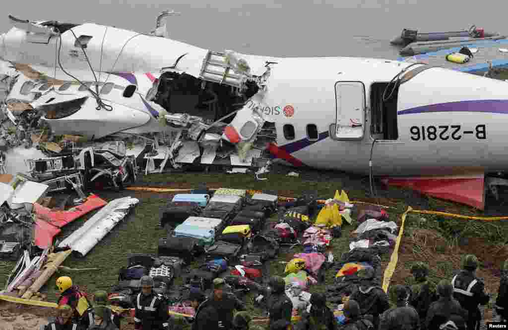 Baggage is placed near the wreckage of TransAsia Airways plane Flight GE235 after it&nbsp;crashed into the river shortly after taking off, in New Taipei City, Taiwan. The death toll has risen to 31, officials said. &nbsp;