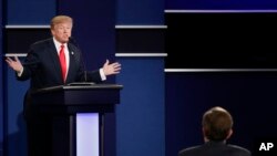 FILE - Then Republican presidential nominee Donald Trump answers a question during the third presidential debate in Las Vegas, Oct. 19, 2016. Despite his own tweets, Trump has denied having made claims that climate change was a hoax invented by China.