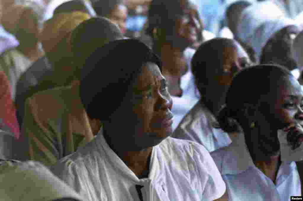 A woman reacts during a church service to commemorate the second anniversary of the 2010 earthquake in Port-au-Prince, January 12, 2012.