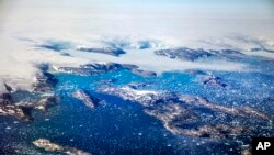 Icebergs float in a fjord after calving off from glaciers on the Greenland ice sheet in southeastern Greenland, Thursday, Aug. 3, 2017. (AP Photo/David Goldman)