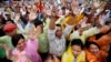 Cambodians raise their arms as they gather during a protest at Freedom Park in central Phnom Penh, Dec. 17, 2013.