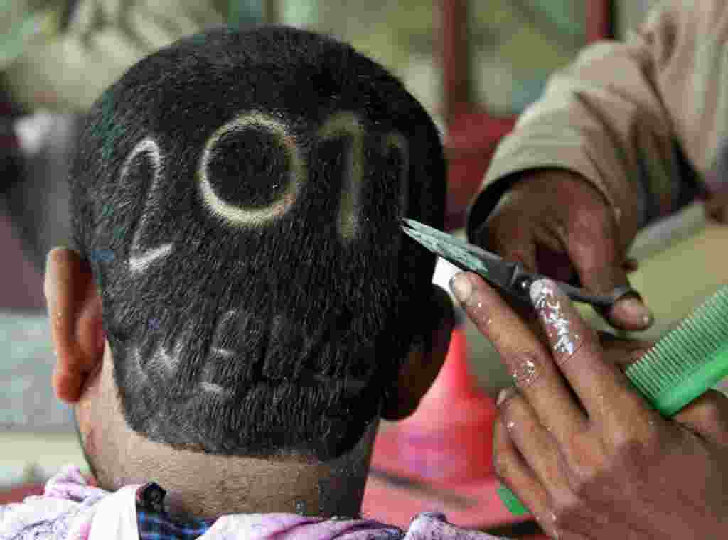 Dec. 27: A man gets a haircut depicting 2011 to welcome the new year at a barbershop in the northern Indian city of Allahabad. 2010. (Jitendra Prakash/Reuters)