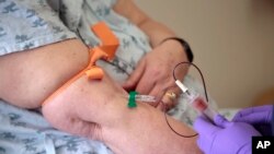 FILE - A patient has her blood drawn at Jefferson University Hospital in Philadelphia, Pennsylvania, April 28, 2015.