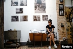 Artist Vivian Rodriguez sits at home where she displays her work, in Havana, Cuba, September 13, 2018. Picture taken on September 13, 2018. REUTERS/Alexandre Meneghini