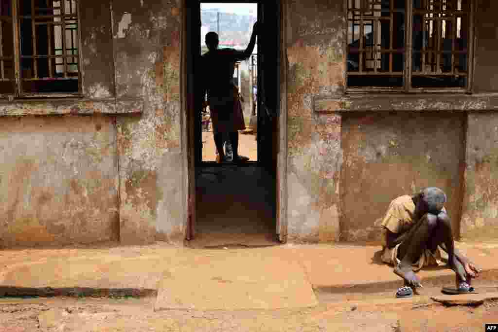 An inmate sits in the sun at the Central Prison in Freetown, Sierra Leone.&nbsp;According to many NGOs, prisoners have extremely hard living conditions and have suffered for years from a lack of access to food and water.