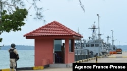 FILE - Cambodian navy personnel guard a jetty at Ream Naval Base in Preah Sihanouk province during a government organized media tour, July 26, 2019.