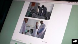 Gambar ini ditampilkan di layar di Beijing, Minggu, 9 Juli 2017, menunjukkan foto yang diambil dari situs resmi Rumah Sakit Pertama China Medical University di Shenyang, Cina utara, menunjukkan Dr. Markus W. Buchler dari Jerman (atas) dan Dr. Joseph Herman dari Amerika (dari Universitas Heidelberg), MD Anderson Cancer Center di University of Texas (bawah), bertemu dengan peraih hadiah Nobel Perdamaian China Liu Xiaobo di rumah sakit tersebut. (AP Photo / Andy Wong)