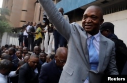 FILE - Former Congolese Interior Minister Emmanuel Ramazani Shadary waves to his supporters as he arrives to file his candidacy for the presidential election, at the Congo's electoral commission head offices at the Gombe Municipality in Kinshasa.