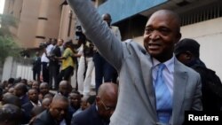 FILE - Former Congolese Interior Minister Emmanuel Ramazani Shadary waves to his supporters as he arrives to file his candidacy for the presidential election, at the Congo's electoral commission head offices at the Gombe Municipality in Kinshasa, Democratic Republic of the Congo, Aug. 8, 2018. 