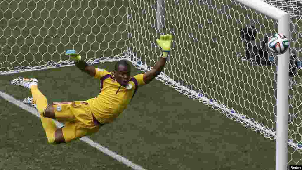 Nigeria's goalkeeper Vincent Enyeama jumps to make a save on a shot at goal by France's Paul Pogba.