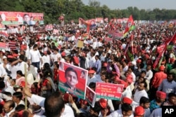 Samajwadi Party supporters hold the poster of their leader Akhilesh Yadav for the launch of the party's election campaign for the state of Uttar Pradesh, in Lucknow, India, Nov. 3, 2016. The opaque funding of political parties has become a growing source of concern in the world’s largest democracy.