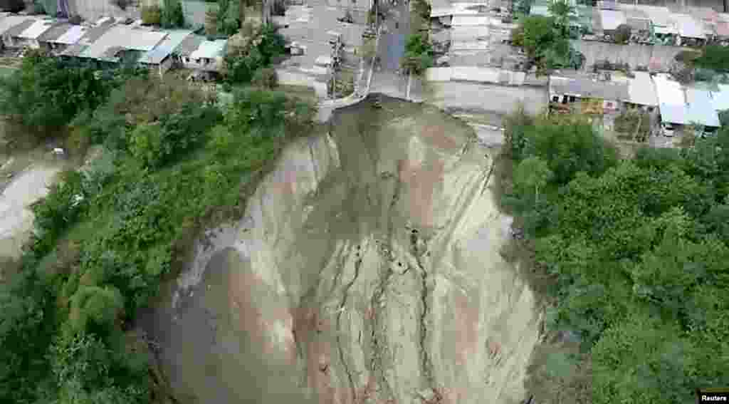 Houses are seen after a landslide caused by the rains due to low pressure in recent days, in Santa Lucia Residency in San Salvador, El Salvador in this photo provided by Communications Office of Governmental Ministry of El Salvador.