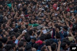 Kashmiri Muslims carry the body of Fayaz Ahmad Hamal, a local rebel, during his funeral procession in Srinagar, Indian-controlled Kashmir, May 5, 2018.