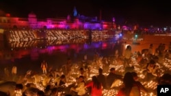 Devotees light earthen lamps on the banks of the River Sarayu as part of Diwali celebrations in Ayodhya, India, India, Nov. 6, 2018.
