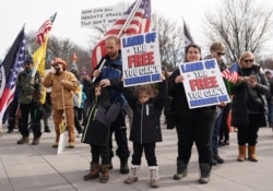 Demonstrators participate in a “Defeat the Mandates” march in Washington, DC, Jan. 23, 2022.