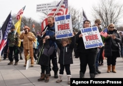 Demonstrators participate in a “Defeat the Mandates” march in Washington, DC, Jan. 23, 2022.